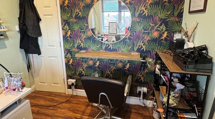 Chic salon station at Jodie Sweeting Beauty, Bristol, England, GB with vibrant wallpaper and modern decor.