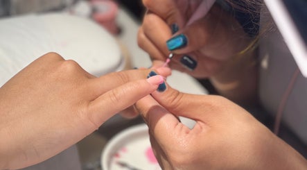 Nail artist creating a pink manicure at NǐĦǎo Pisces Nails Hair Beauty唐人美发 in L-imsida, MT.