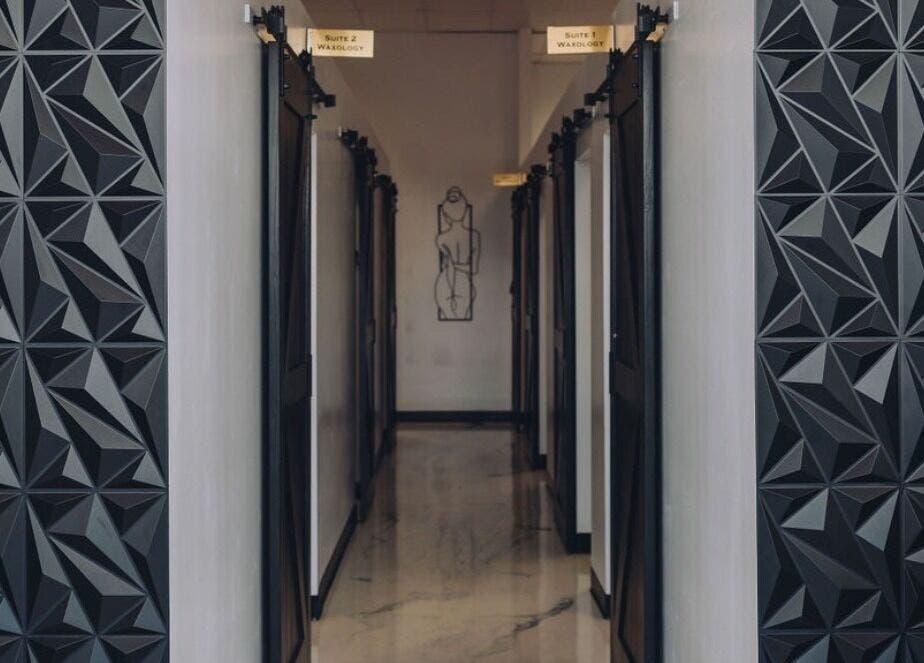 Modern hallway at Waxology Waxing Studio, Jacksonville, Florida, US with geometric wall patterns.