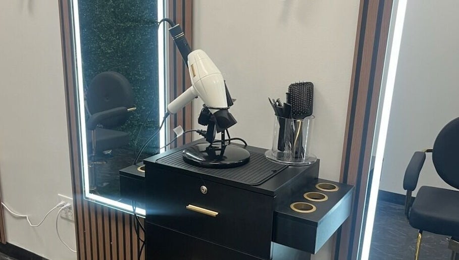 Modern styling station at Blo Me Ou', Blow Dry Bar in Jacksonville, Florida, US featuring sleek salon tools.