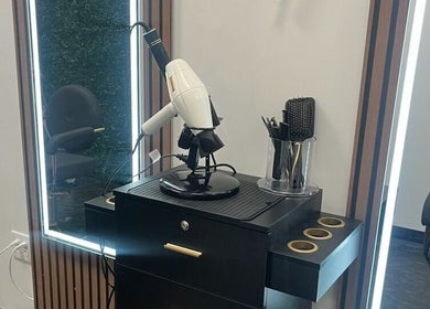 Modern styling station at Blo Me Ou', Blow Dry Bar in Jacksonville, Florida, US featuring sleek salon tools.