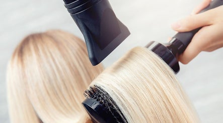Professional blowout at Blo Me Ou', Blow Dry Bar, Jacksonville, Florida, US enhances sleek hair finish.