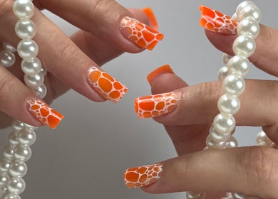 Vibrant orange nail art with pearls at Panut Andreea | Nail Artist & Trainer in Strovolos, Nicosia, CY.