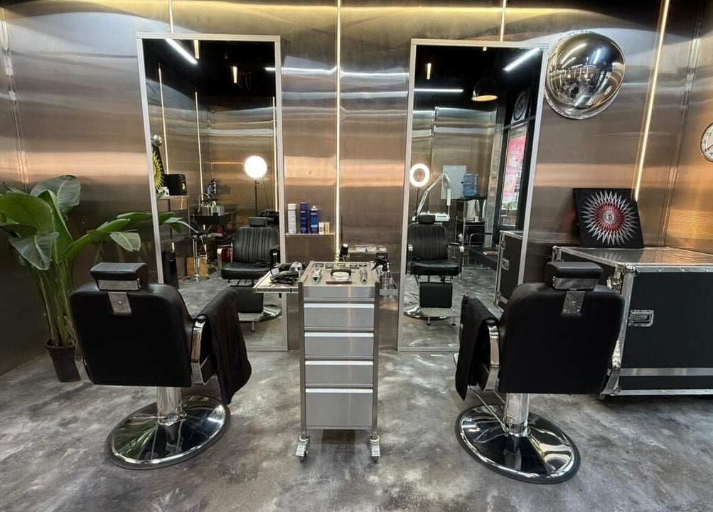Modern interior of Dialan Gents Salon L.L.C in Dubai, AE, featuring sleek styling chairs and contemporary decor.