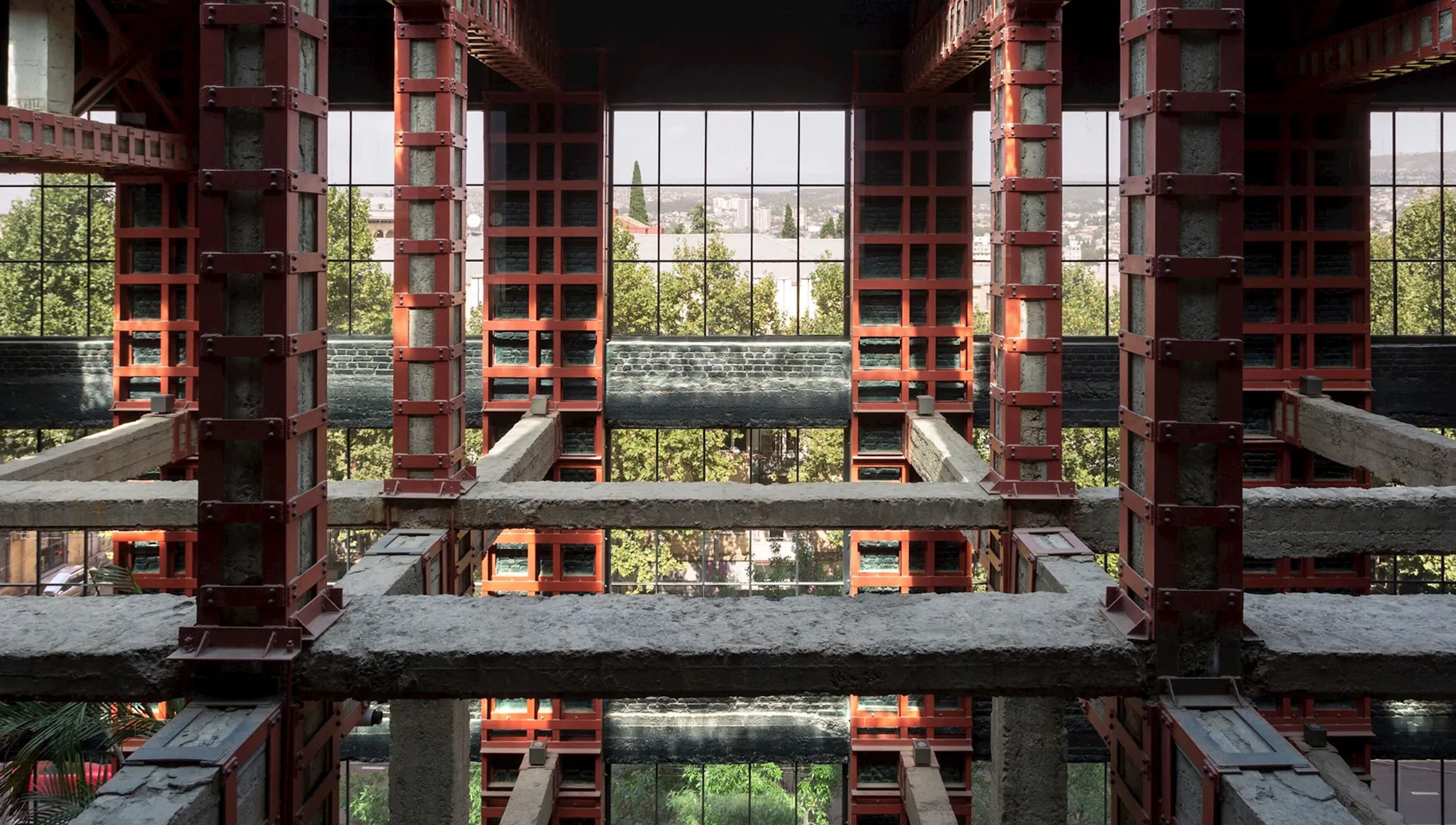 Industrial architecture view inside Sadalako, T'bilisi, GE with greenery visible through large windows.