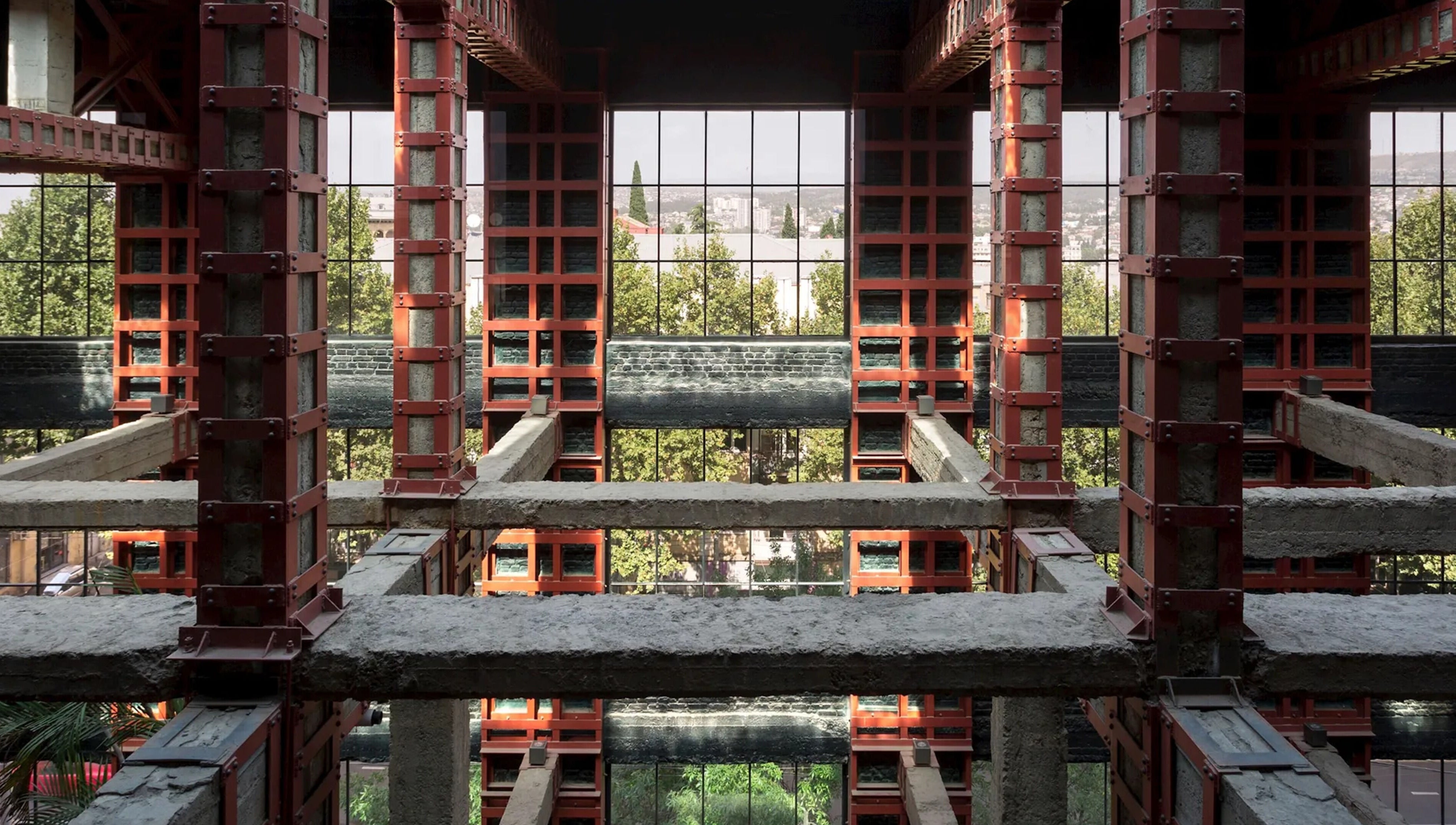 Industrial architecture view inside Sadalako, T'bilisi, GE with greenery visible through large windows.