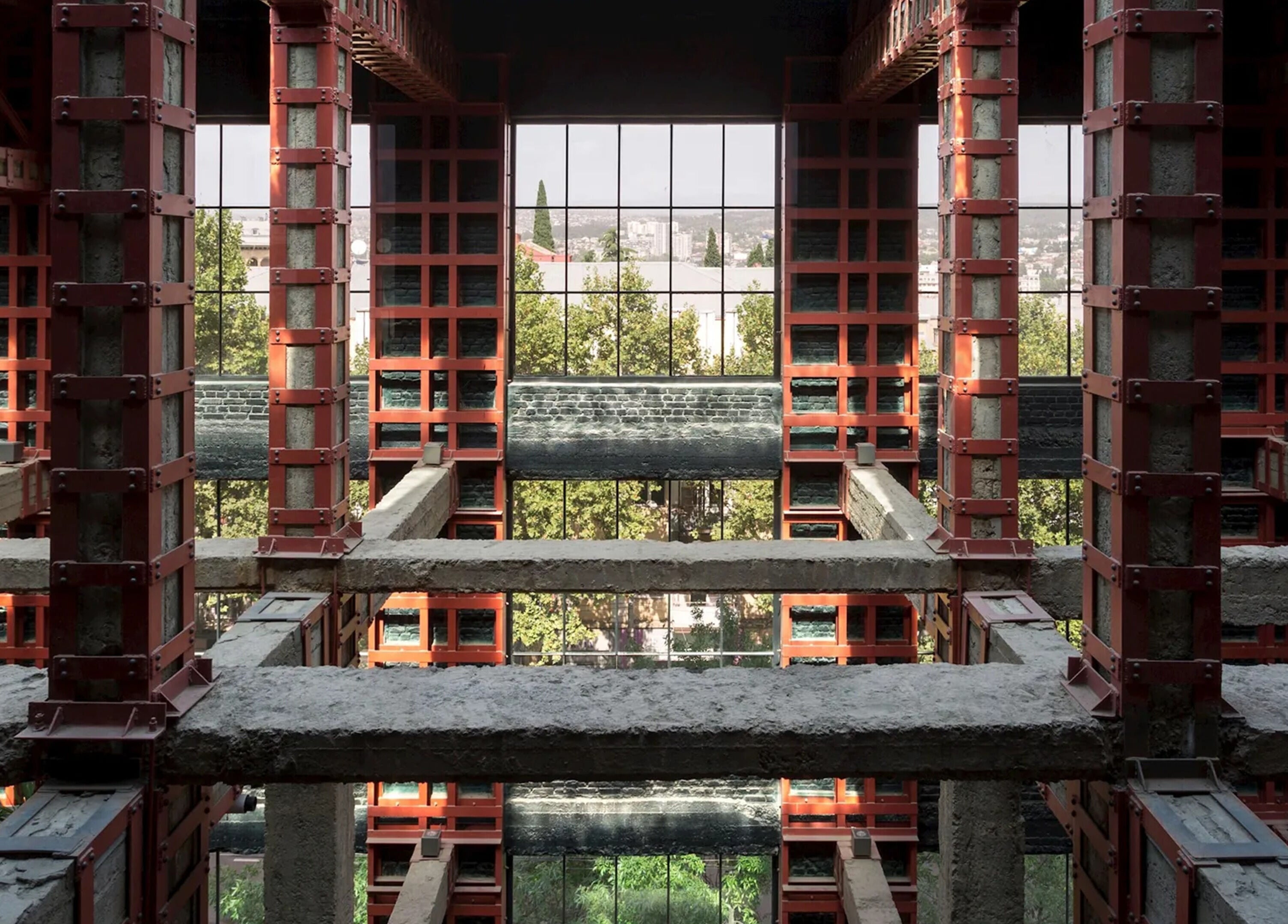 Industrial architecture view inside Sadalako, T'bilisi, GE with greenery visible through large windows.