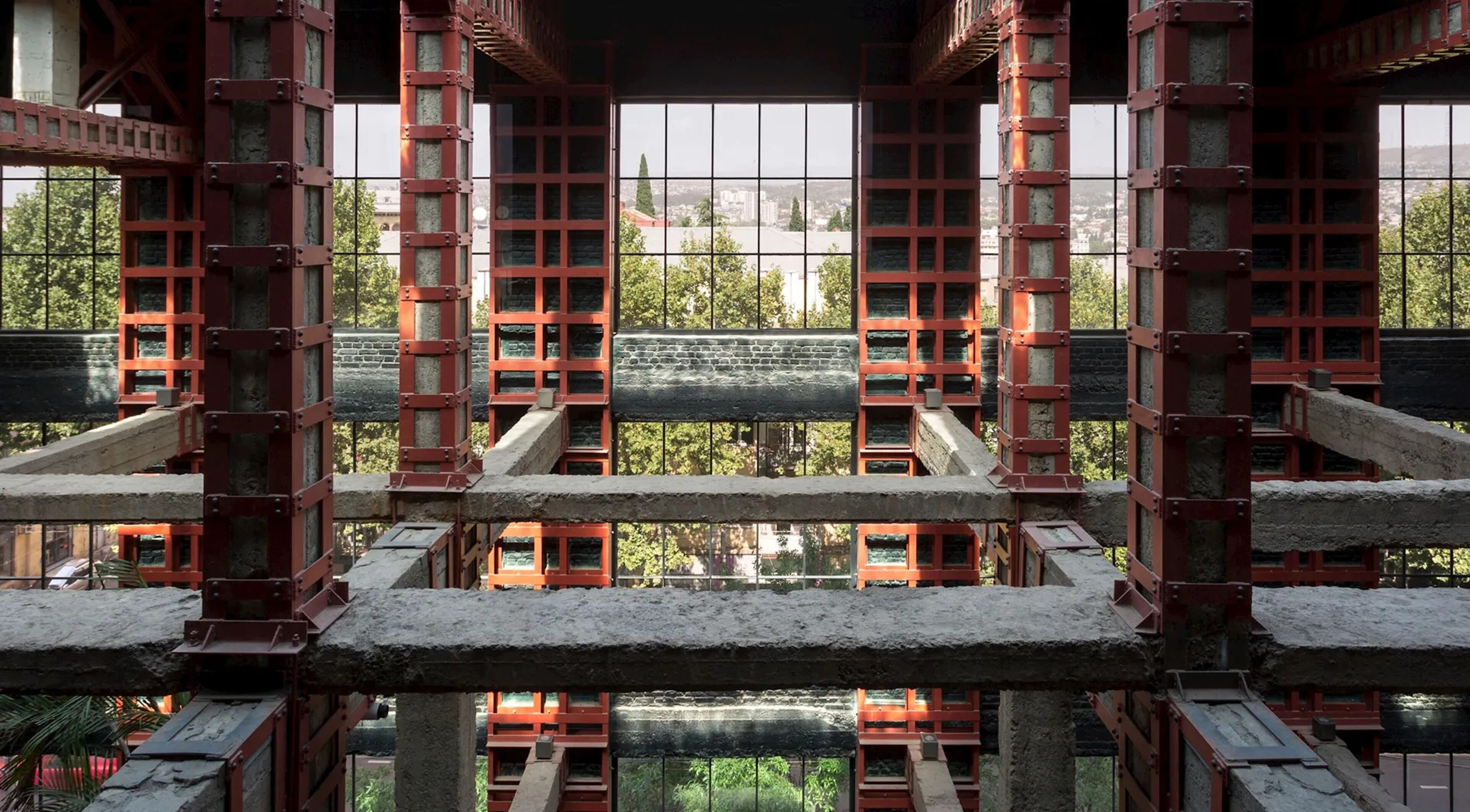 Industrial architecture view inside Sadalako, T'bilisi, GE with greenery visible through large windows.