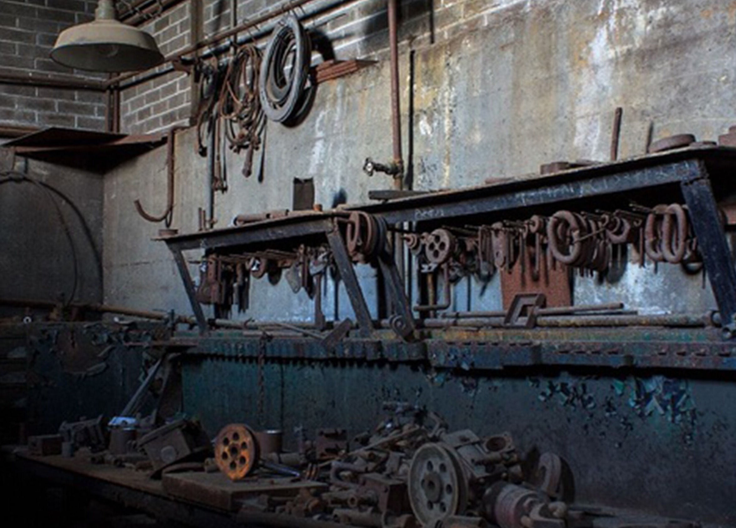 Rustic industrial workshop interior at Sadalako, T'bilisi, GE, featuring vintage tools and machinery.