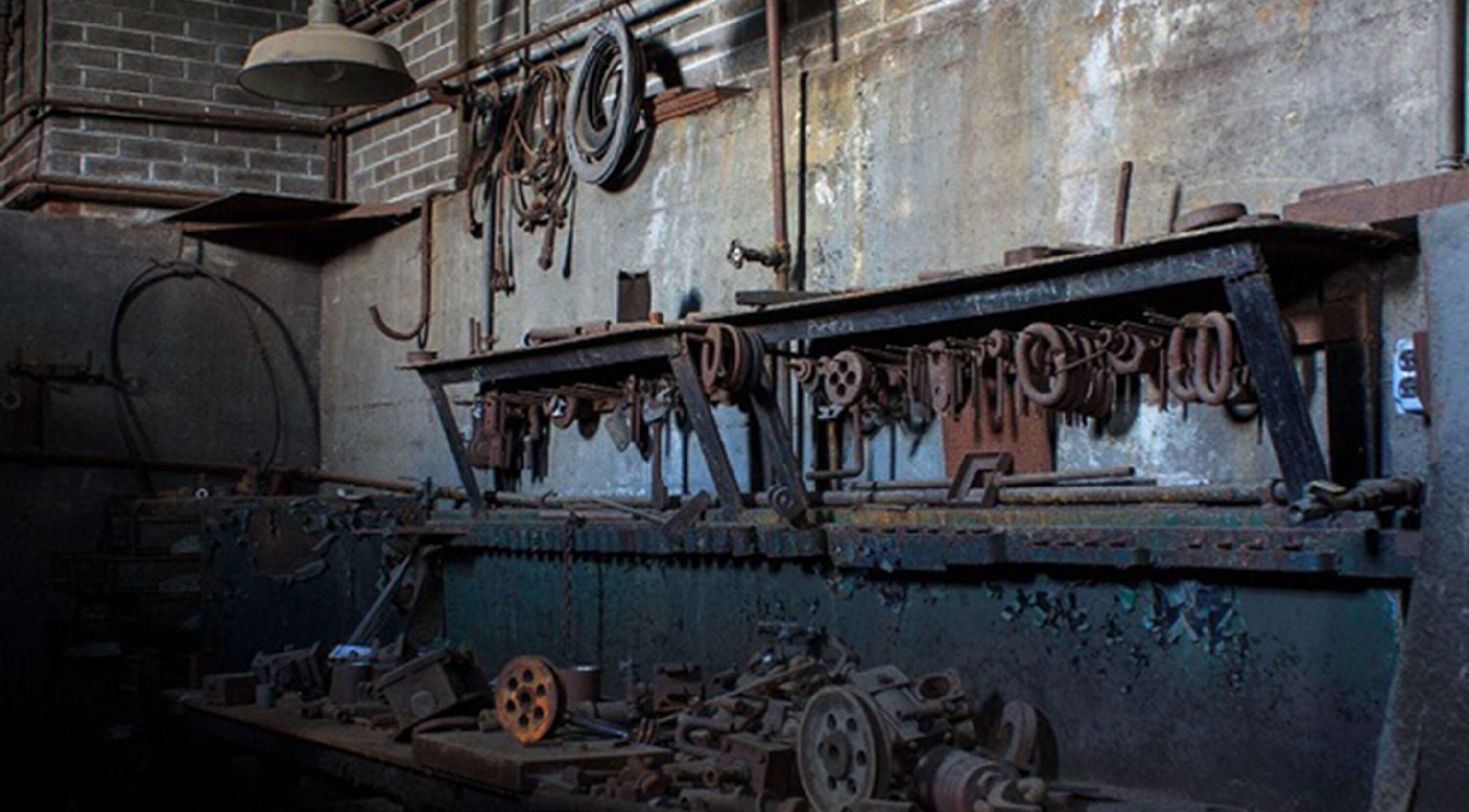 Rustic industrial workshop interior at Sadalako, T'bilisi, GE, featuring vintage tools and machinery.