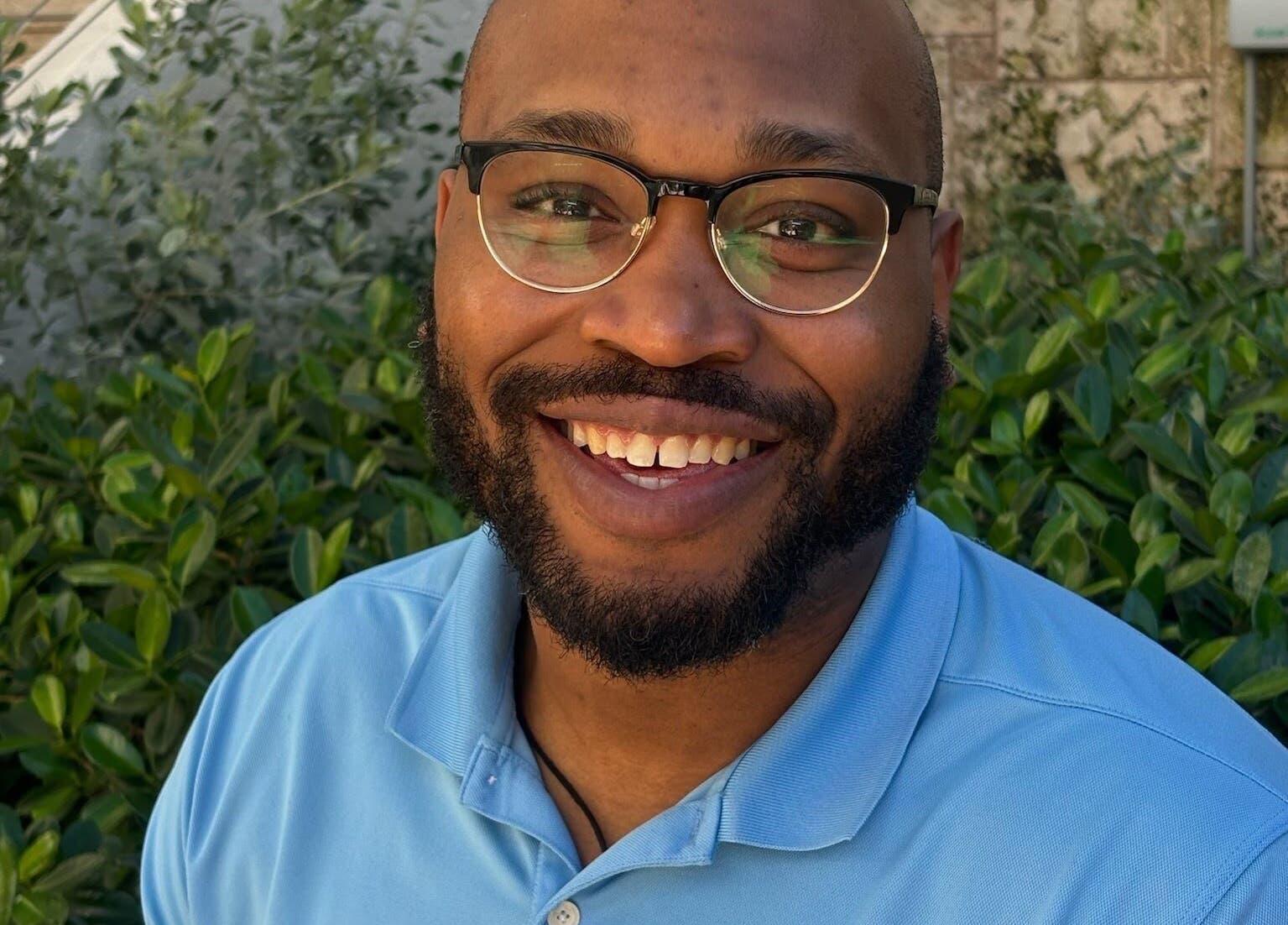 Happy individual outside Unifyed Therapy, Stuart, Florida, US, enjoying nature and wellness vibes.