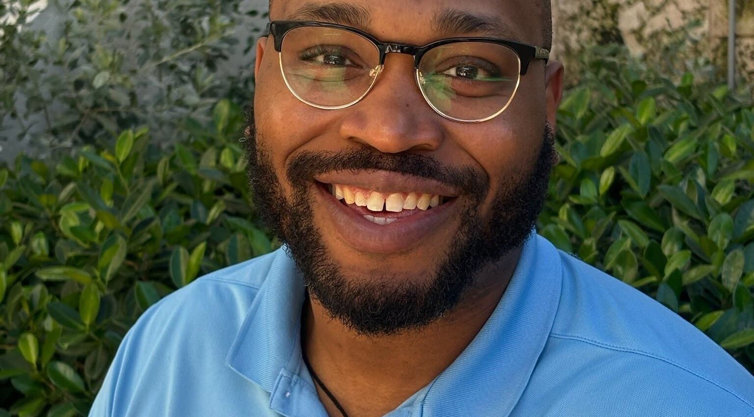 Happy individual outside Unifyed Therapy, Stuart, Florida, US, enjoying nature and wellness vibes.