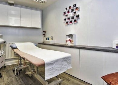 Modern therapy room at Addlestone Therapy, Addlestone, England, GB with spa bed and equipment.