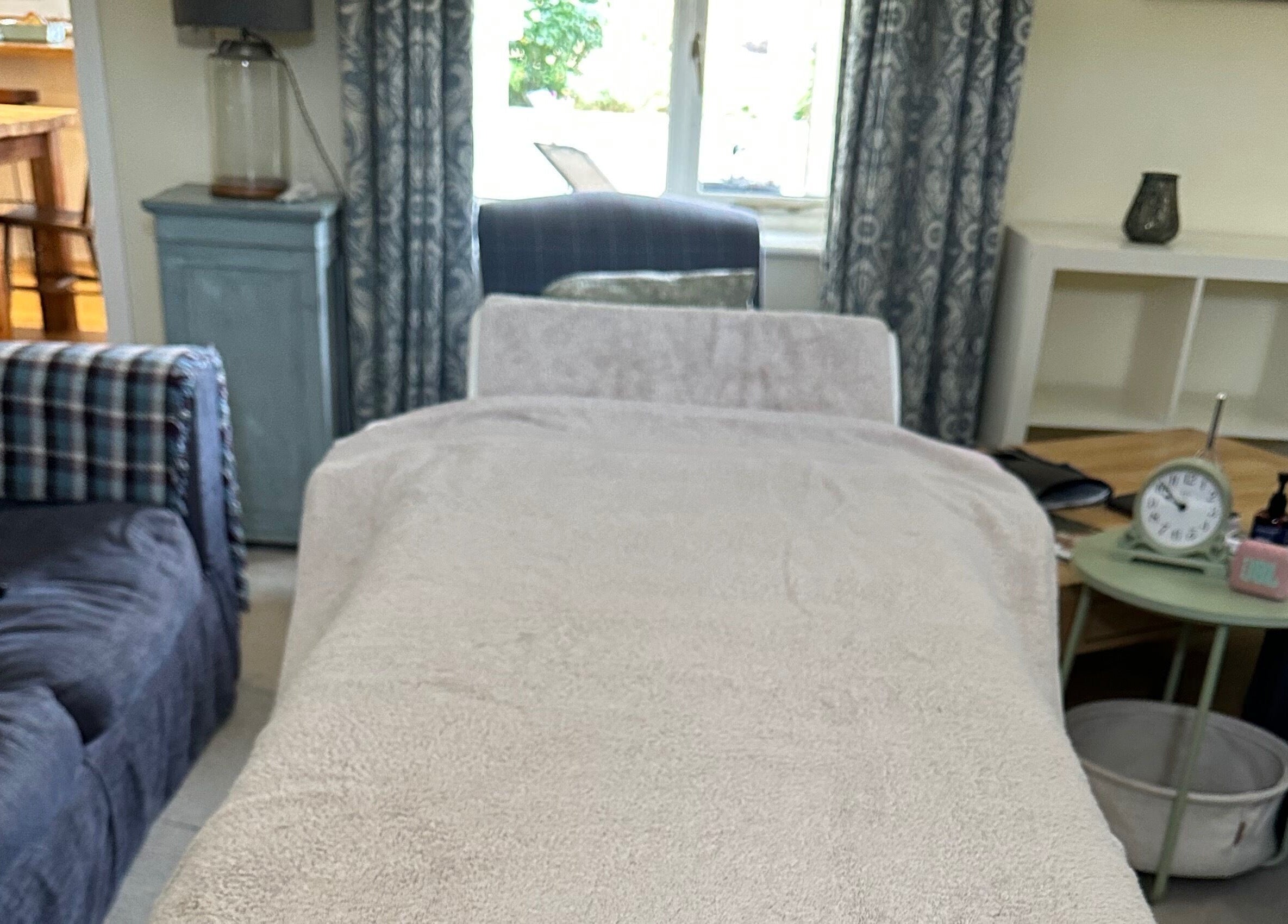 Relaxing massage bed setup at Pasithea Massage by Appointment, Ventnor, England, GB offering a serene atmosphere.