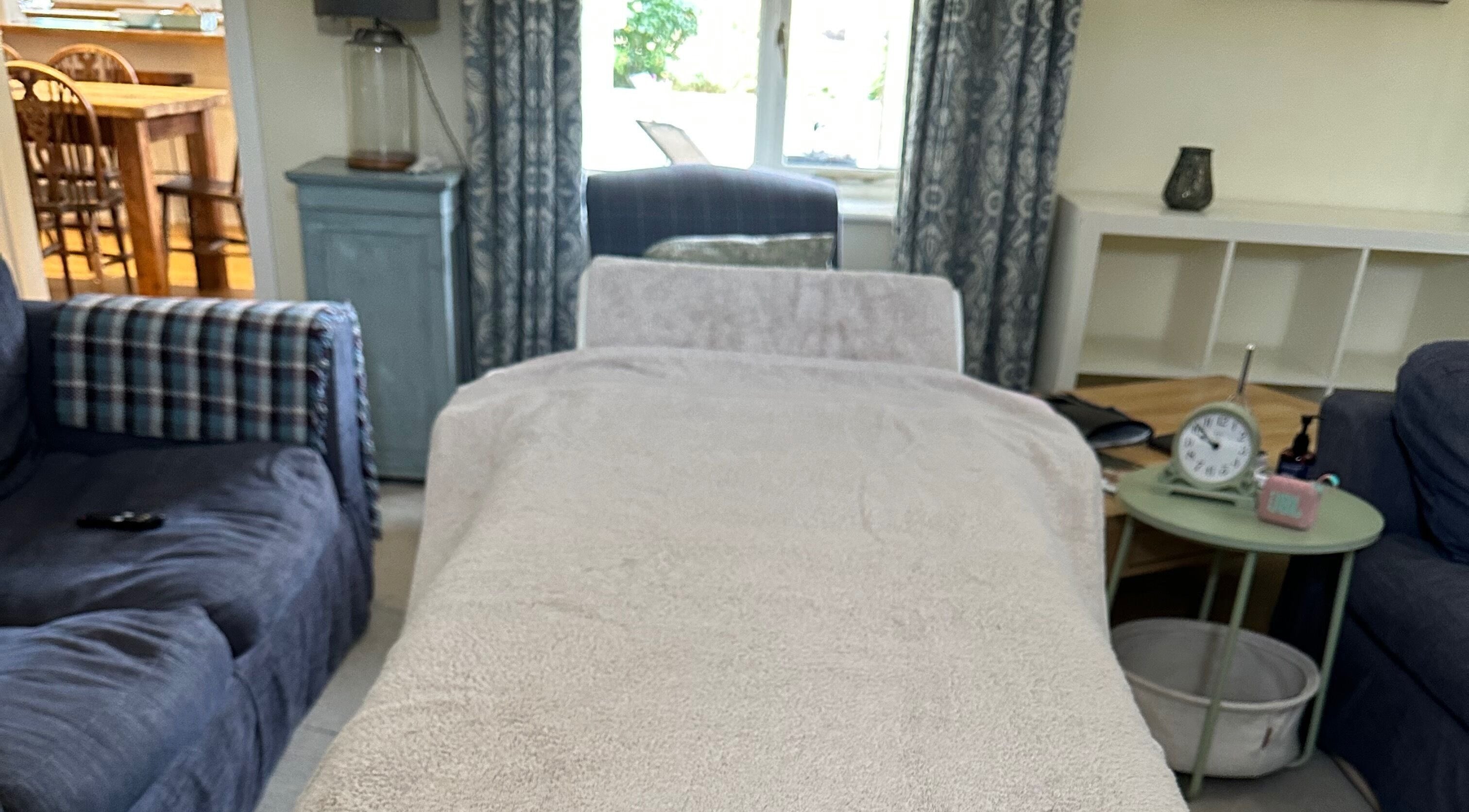 Relaxing massage bed setup at Pasithea Massage by Appointment, Ventnor, England, GB offering a serene atmosphere.