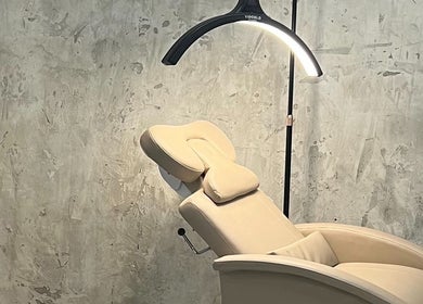 Comfortable treatment chair at Lala Simone Beauty in London, England, GB, set against a textured wall.