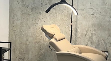 Comfortable treatment chair at Lala Simone Beauty in London, England, GB, set against a textured wall.