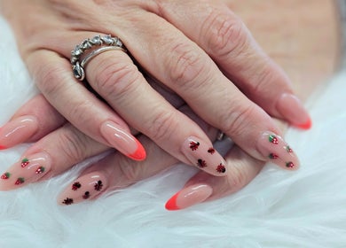 Elegant manicure with berry designs at Dark Envy Nails, Swaffham, England, GB, featuring red tips.