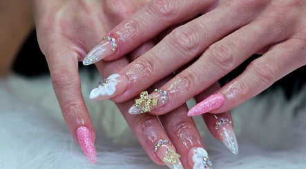 Intricate nail design at Dark Envy Nails, Swaffham, England, GB with pink glitter and 3D embellishments.
