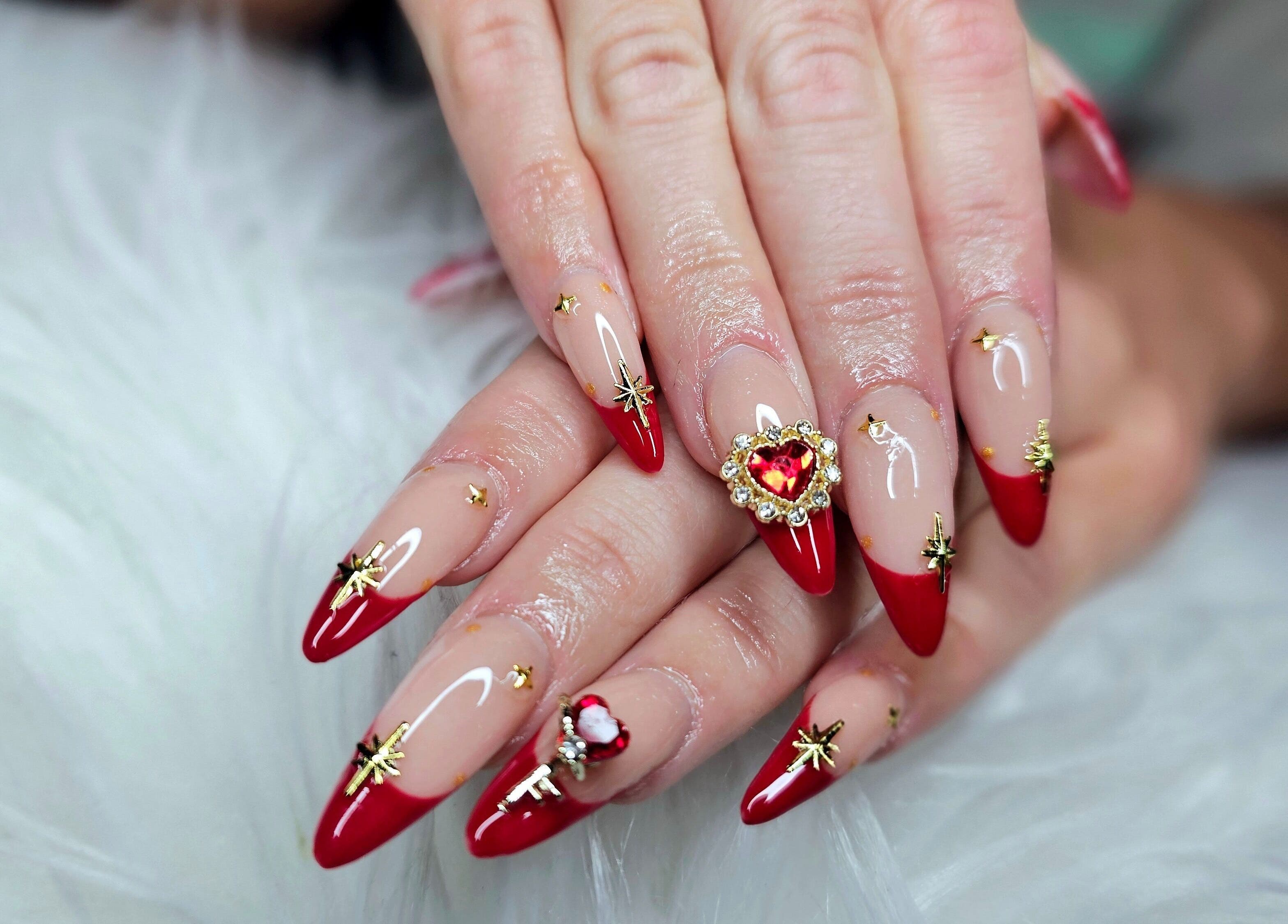 Exquisite red and gold nail art from Dark Envy Nails, Swaffham, England, GB, showcasing intricate design.