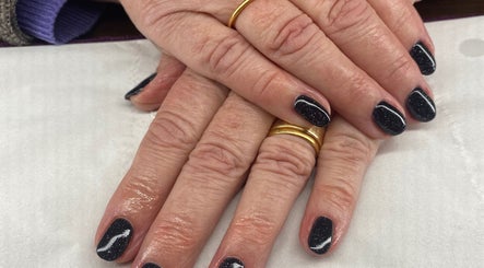 Sparkling dark nails with gold rings at Harmony Nails & Beauty, Evesham, England, GB.