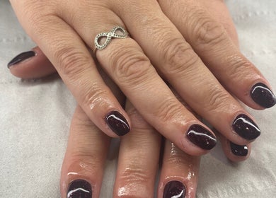 Elegant dark purple nails with an infinity ring at Harmony Nails & Beauty, Evesham, England, GB.