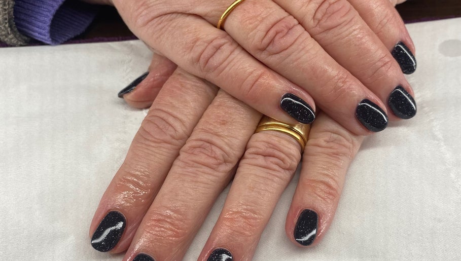 Elegant dark nail art at Harmony Nails & Beauty, Evesham, England, GB. Features a glossy, starry finish.