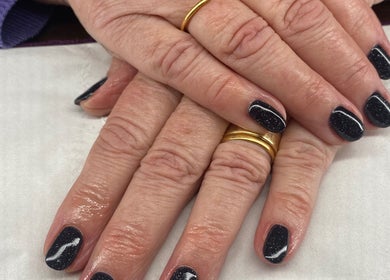 Elegant dark nail art at Harmony Nails & Beauty, Evesham, England, GB. Features a glossy, starry finish.