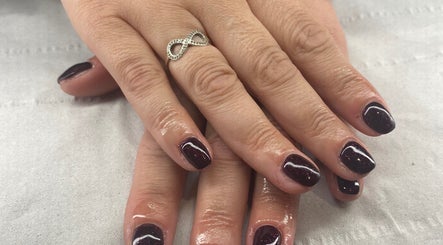 Elegant maroon manicure at Harmony Nails & Beauty, Evesham, England, GB. Highlighting luxury nail care.