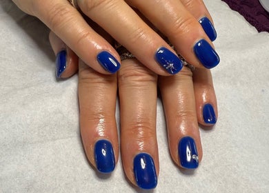 Bright blue polished nails at Harmony Nails & Beauty in Evesham, England, GB showcase artistry and care.