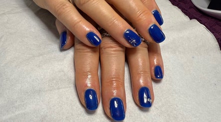 Bright blue polished nails at Harmony Nails & Beauty in Evesham, England, GB showcase artistry and care.