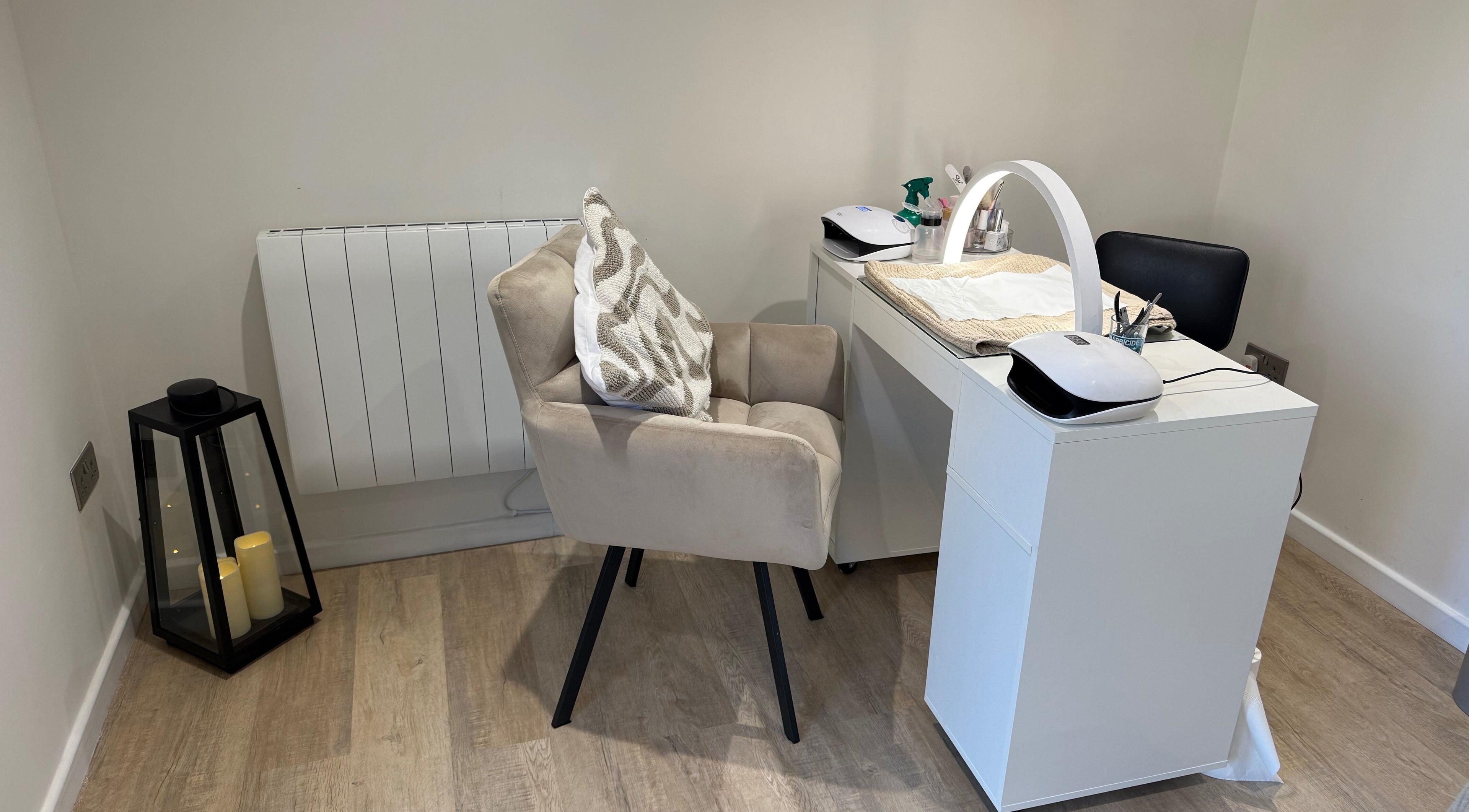 Comfortable nail station at Harmony Nails & Beauty, Evesham, England, GB, featuring a plush chair and sleek desk.