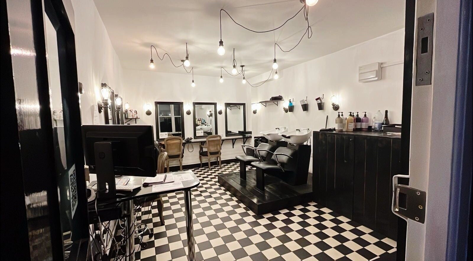 Stylish salon interior at Blow Dry Express - Monument, London, United Kingdom, GB with modern decor and workstations.