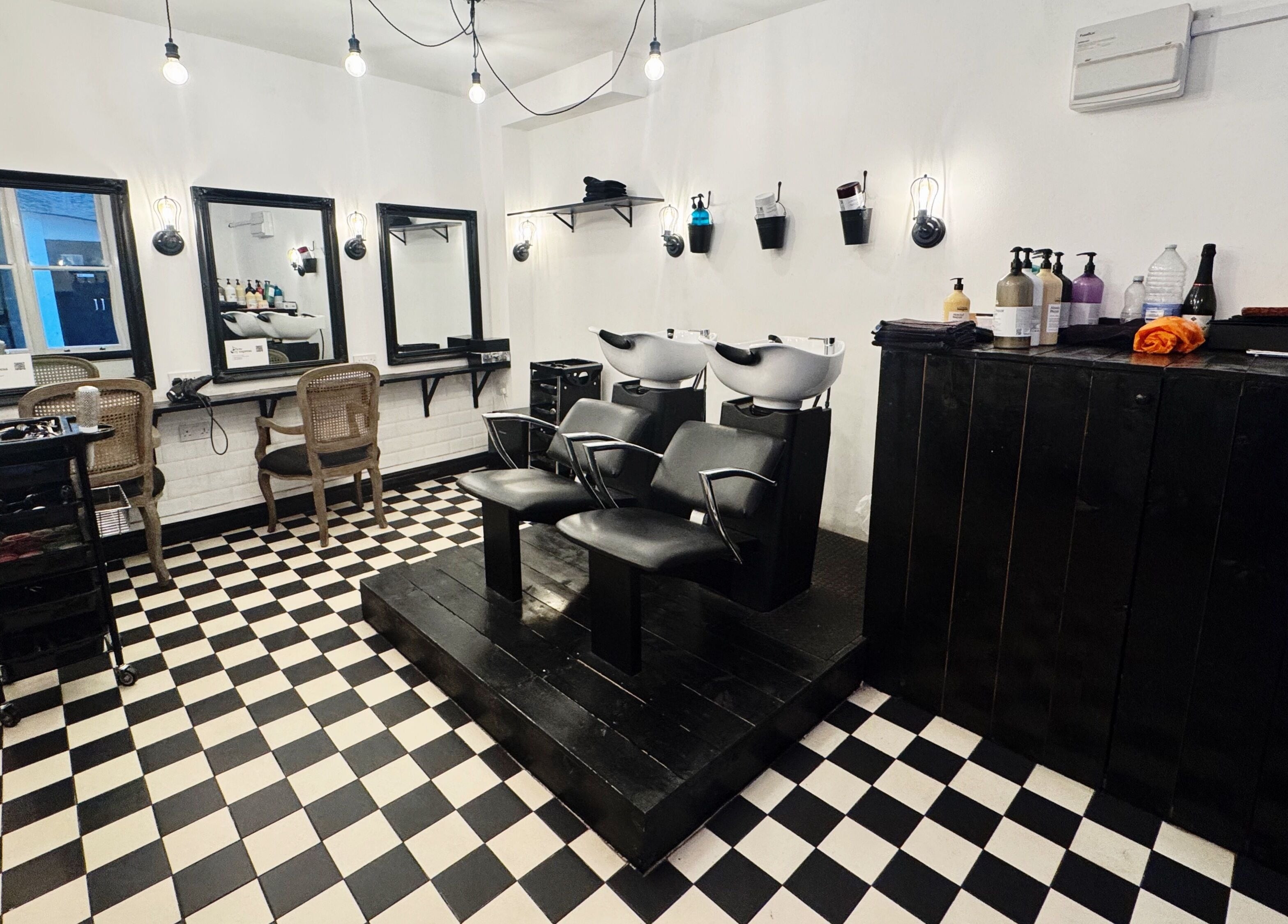 Stylish salon interior at Blow Dry Express - Monument, London, United Kingdom, GB with modern wash stations.