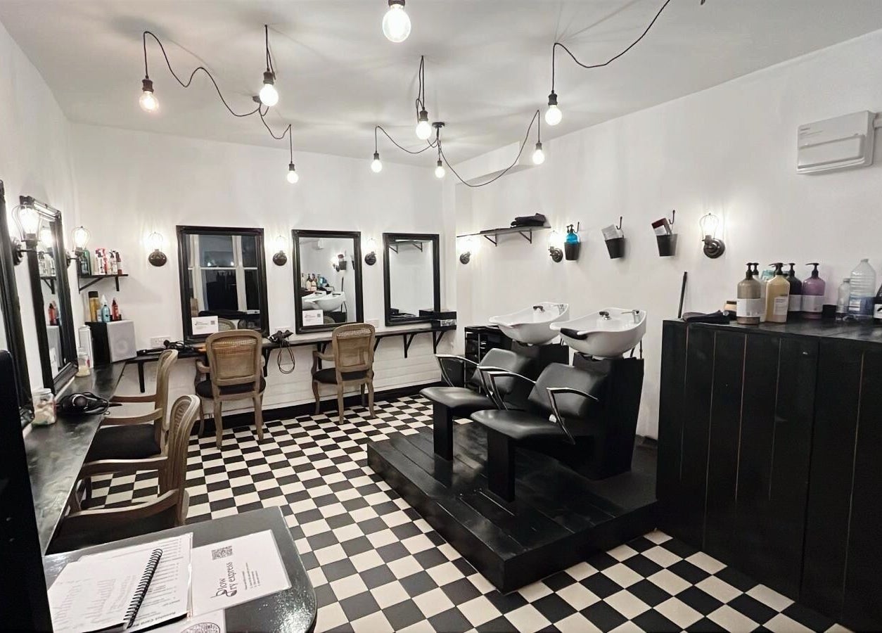 Elegant interior of Blow Dry Express - Monument in London, United Kingdom, GB, featuring stylish black and white decor.