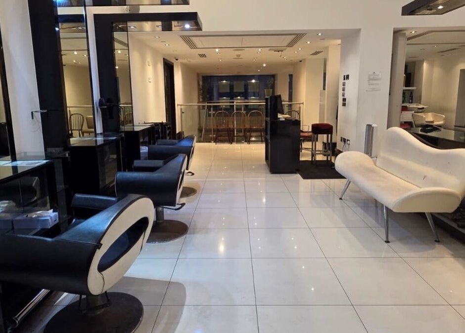 Chic interior of Blow Dry Express - St Pauls, London, United Kingdom, GB, featuring modern black salon chairs and sleek design.
