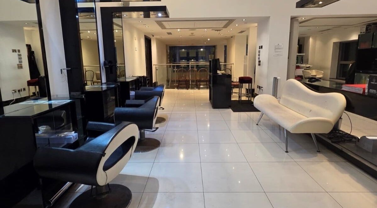Chic interior of Blow Dry Express - St Pauls, London, United Kingdom, GB, featuring modern black salon chairs and sleek design.