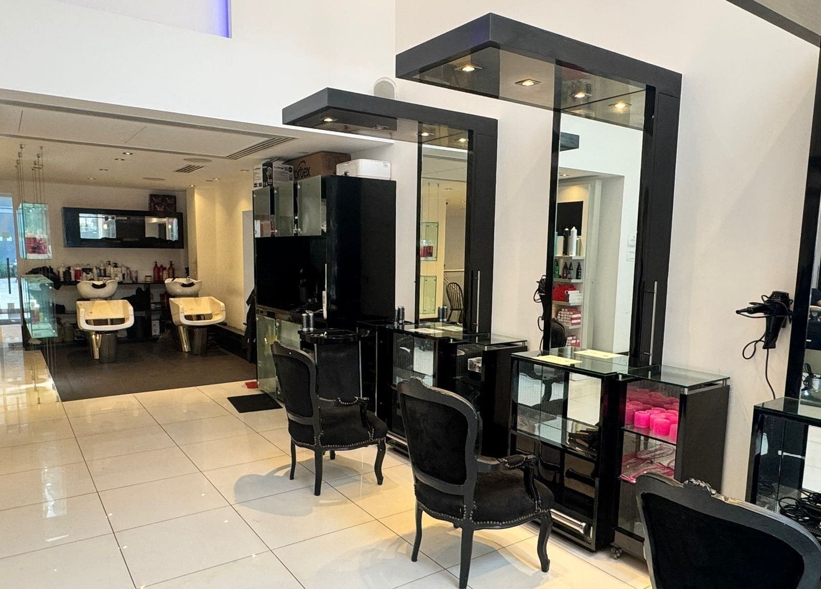 Modern salon interior at Blow Dry Express - St Pauls in London, United Kingdom, GB with sleek workstations.