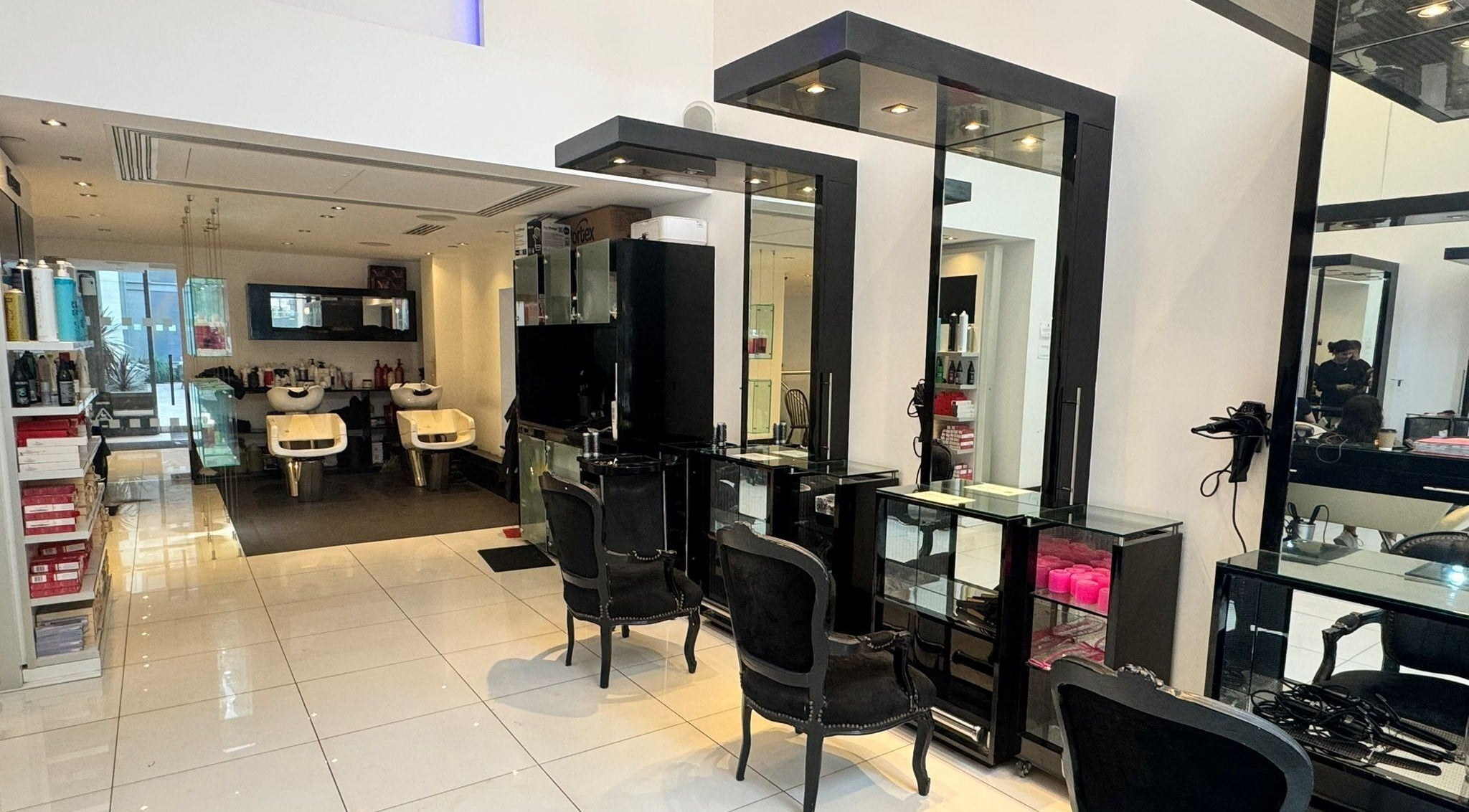 Modern salon interior at Blow Dry Express - St Pauls in London, United Kingdom, GB with sleek workstations.