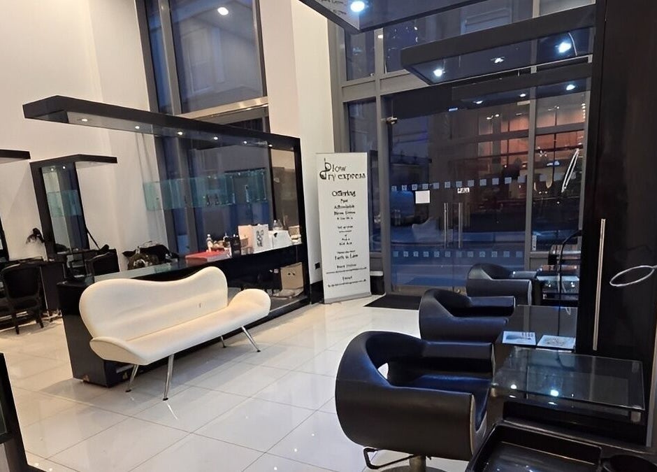 Modern salon interior at Blow Dry Express - St Pauls, London, United Kingdom, GB with sleek seating and mirrors.