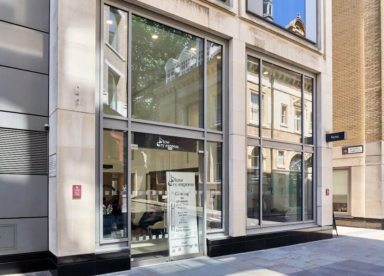 Entrance of Blow Dry Express - St Pauls in London, United Kingdom, GB, showcasing modern glass facade.