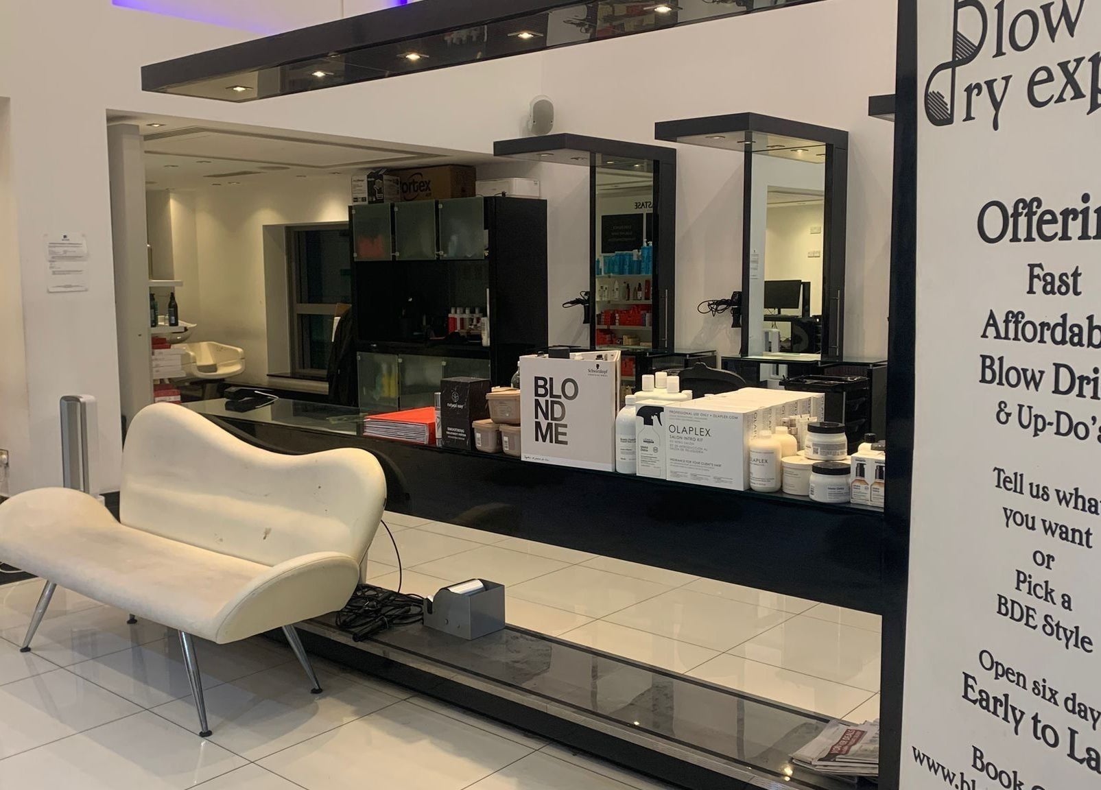 Modern salon interior at Blow Dry Express - St Pauls, London, United Kingdom, GB with stylish decor and products.