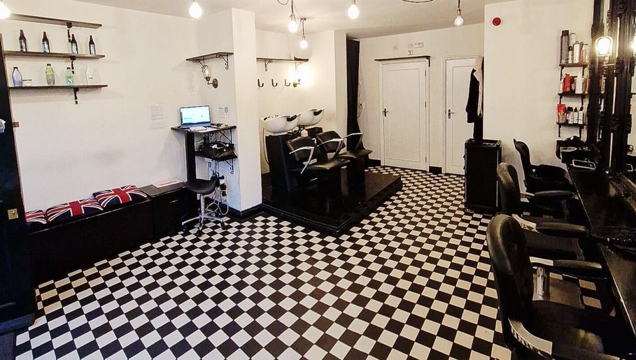 Interior of Blow Dry Express - Liverpool Street in London, United Kingdom, featuring stylish chairs and checkered flooring.