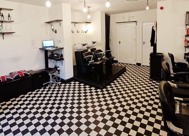 Interior of Blow Dry Express - Liverpool Street in London, United Kingdom, featuring stylish chairs and checkered flooring.