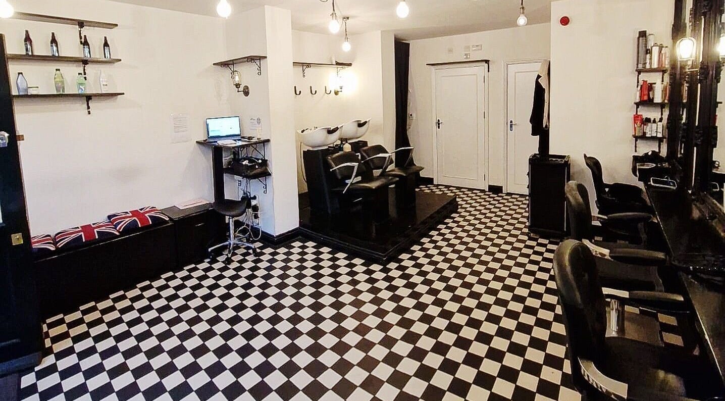 Interior of Blow Dry Express - Liverpool Street in London, United Kingdom, featuring stylish chairs and checkered flooring.