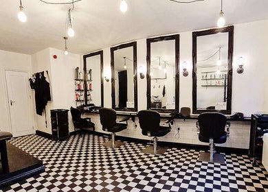 Modern salon layout at Blow Dry Express - Liverpool Street, London, United Kingdom, GB, with stylish mirrors.