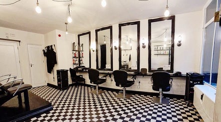 Modern salon layout at Blow Dry Express - Liverpool Street, London, United Kingdom, GB, with stylish mirrors.