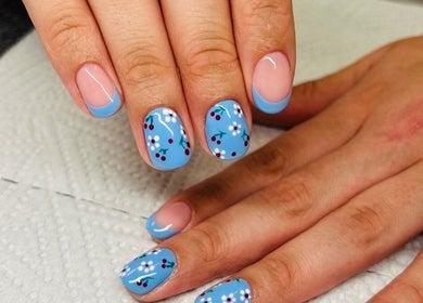 Blue floral nail art at Gloow Nails, Randburg, Gauteng, ZA, showcasing intricate design and creativity.