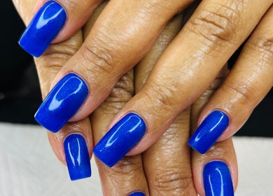 Stylish vivid blue manicure at Gloow Nails on elegant hands in Randburg, Gauteng, ZA.