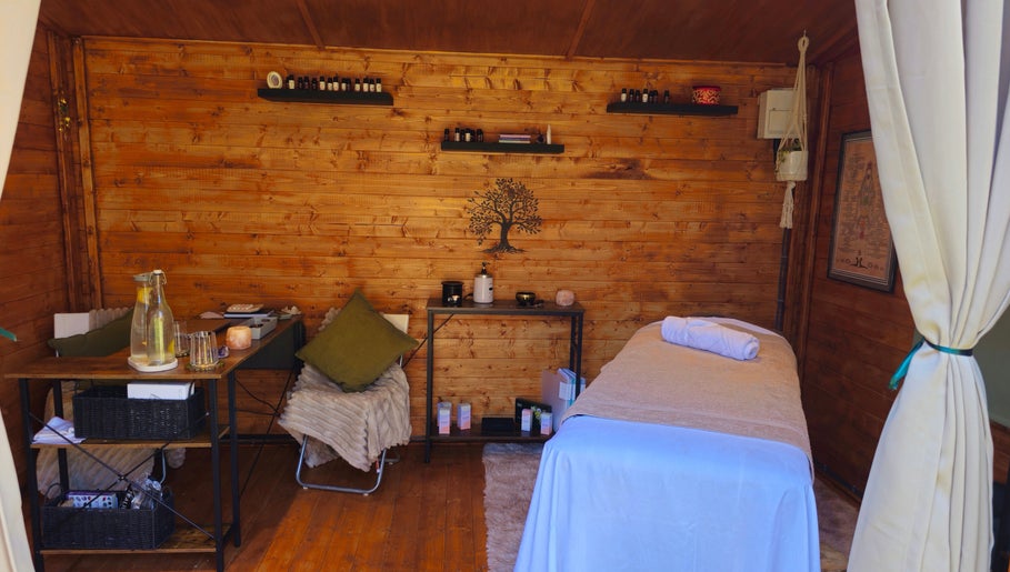 Relaxing massage room at Saltwoods Healing & Massage, Herne Bay, England, GB, featuring a cozy wooden interior.